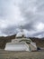 Shanti Palace and rain clouds, Ladakh, India. Holds relics of the Buddha at its base