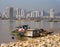 Shanty fishing boats and hut are on the bank of a river