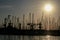 Shape of boat masts and cranes at sunset in Toulon port, France