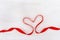 Shape of heart from red ribbon on white wood background. Happy Saint Valentin day. Mother Womens Day concept