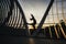 Shape of a woman jumping on a conceptual bridge