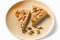 shaped pieces of sweet peanut butter sheet cake with nuts on plate