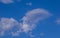 Shapes in white clouds isolated in a blue sky