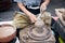 Shaping decorative clay hollow sculpture on pottery wheel with k