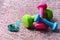 Shaping and fitness equipment. Barbells in green, pink and cyan