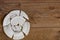 Shards of a broken plate on the wooden floor. Broken white ceramic plate on the wooden floor. Broken dishes. Top view of a damaged