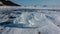 Shards of transparent ice are scattered on the frozen lake.