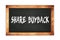 SHARE  BUYBACK text written on wooden frame school blackboard