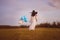 They share a close bond. Rearview shot of a young mother holding her son and balloons outdoors.