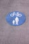 Shared foot and cycle path roundel sign painted on path