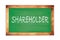 SHAREHOLDER text written on green school board