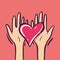 Sharing Hope. Charity and donation. Give and share your love to people. Hands holding a heart symbol. Isolated on pink background