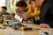 Sharing ideas. Cropped shot of young technicians working with a wiring kit at a stem robotics class. Male teacher is
