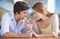 Sharing a milkshake. A young couple sharing a chocolate milkshake while on a date.