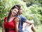 Sharing a musical moment. Young couple shares a pair of earphones in the park.