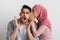 Sharing Secret. Muslim Lady In Hijab Gossiping With Her Shocked Husband