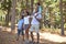 Sharing their passion for nature...ana frican american family enjoying a hike in the woods together.