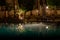 Sharm El Sheikh, Egypt - 02 06 2018: night in the hotel aquamarine pool folded umbrellas empty wooden