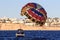 Sharm El Sheikh, Egypt - February 3 2018: Tourists are extremely entertained flying parasailing