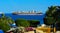 Sharm el-Sheikh, Egypt - March 14, 2018. A huge cargo ship carries containers with cargo in the Red Sea against the blue sky