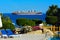 Sharm el-Sheikh, Egypt - March 14, 2018. A huge cargo ship carries containers with cargo in the Red Sea against the blue sky