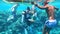 Sharm El Sheikh, Egypt - September 10, 2020: Underwater photographer - diver taking pictures of woman in deep blue water in the Re