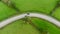 Sharp bend in a road with Chevron warning signs. Aerial view from above.