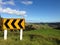 Sharp bend road sign in rural New Zealand