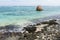 Sharp black rocks at the coast of Anse Union beach. La Digue island