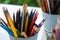 Sharp and blunt color pencils are put in bucket ready to be used in art workshop