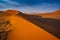 Sharp border of light and shadow over the crest of the dune. The Namib-Naukluft at sunset. Namibia, South Africa. The concept of e
