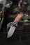 A sharp bright knife for a tourist and a hunter. Hunting knife with an orange handle