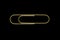 Sharp and clear view of isolated golden paperclip on black background surface