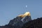 Sharp Himalayan mountain peak covered in snow with the moon in the background at sunrise  Everest Base Camp trek  Nepal