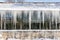 Sharp icicles hanging down from a roof tropical glasshouse in winter