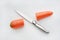 Sharp knife cut half carrot on white background
