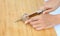 Sharp knife on woman hands cut Shiitake mushroom on wooden block