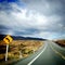 Sharp left bend in road for driving on Desert Road, New Zealand, NZ