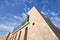 Sharp lines from modern architecture against a blue sky.