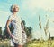 Sharp looking blonde walking through meadow.