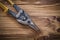 Sharp metal tin snips on vintage wooden board top view construct