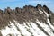 Sharp mountain peaks. Mountains are covered with glaciers. View from helicopter flight altitude