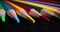 Sharp multicolored pencils on black background