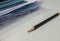 Sharp pencil with business documents pile on office desk