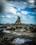 sharp and rough cliff rocks emerging from the water of the Australian coast line