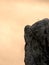 Sharp sandstone cliffs above deep misty valley. Rocks sticking up from fog