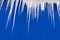Sharp Spikes of Dripping Cold Icicles in Winter