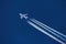 Sharp telephoto close-up of jet plane aircraft with contrails