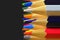 The sharp tips of the pencils. Bright colored pencils. Colored pencils on black background with selective focus. Write