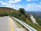 Sharp turn of mountain road, yellow marking of roadside